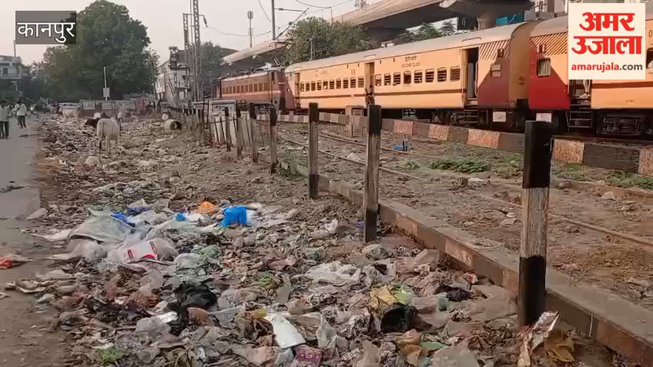 Passengers reach the station by navigating past piles of filth along the railway tracks